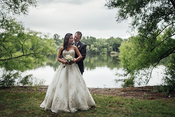 Artistic B & G in front of lake - groom holding bride