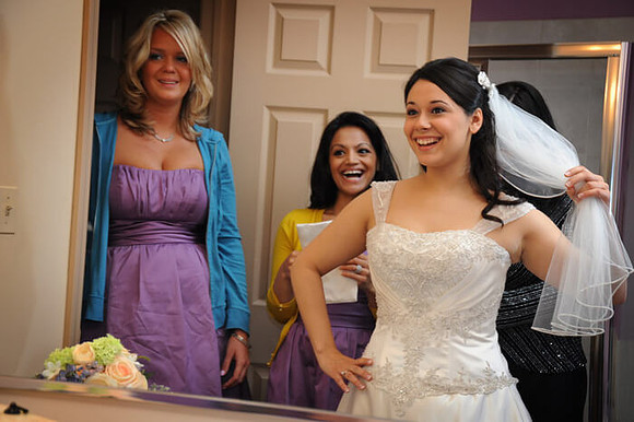 Photojournalistic Bride in mirror with mom