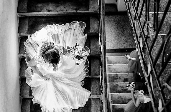 Photojournalistic Bride walking down stairs to ceremony