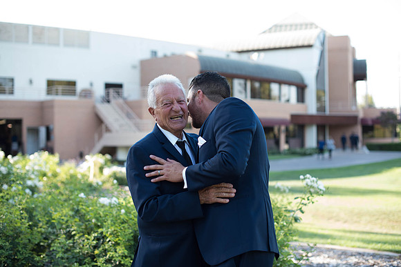 Dad laugh while hugging son