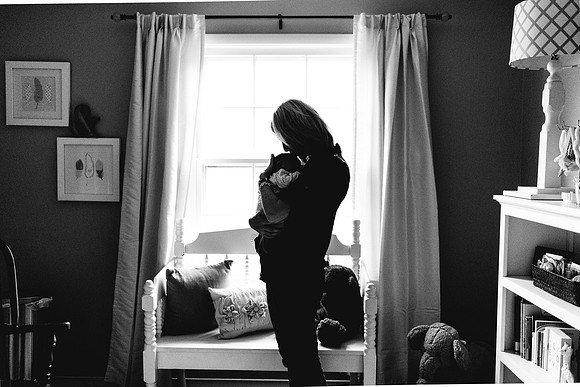 Newborn in mom arms at window silouette b & W