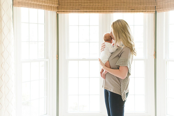 Newborn with mom at window