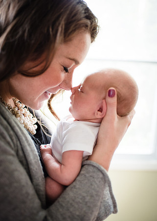 Newborn with mom smiling