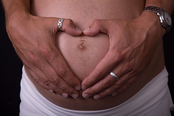 maternity hands over tummy
