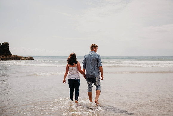 Engagement 21 walking on beach from behind